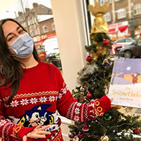 me wearing a Christmas jumper holding a book