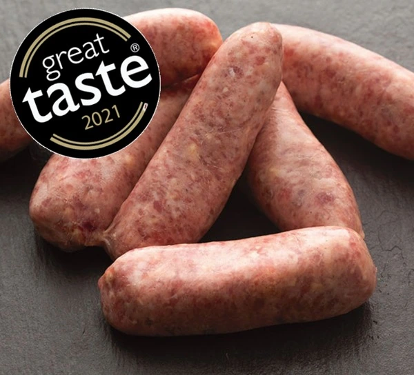 Chilli sausages on slate background with round black and gold Great Taste 2021 logo