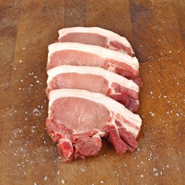 Pork chops on wooden board