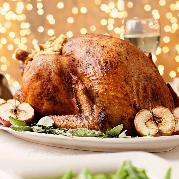 Roast turkey on table with fairy lights