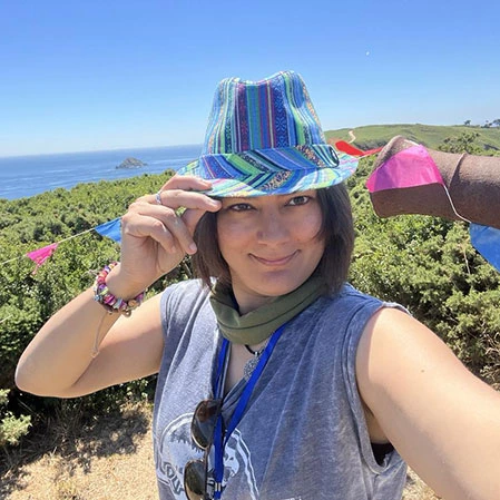 Site creator wearing a stupid rainbow hat against a blue sea background